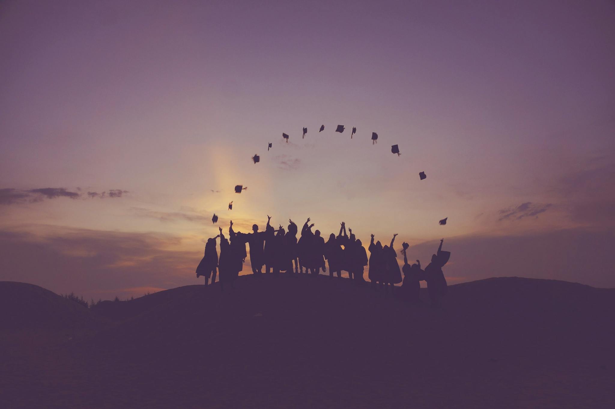 Group of people throwing a graduation cap